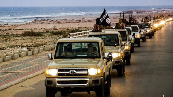 An image made available by propaganda Islamist media outlet Welayat Tarablos on February 18, 2015, allegedly shows members of the Islamic State (IS) militant group parading in a street in Libya's coastal city of Sirte, which lies 500 kilometres (310 miles) east of the capital, Tripoli. Egyptian F-16s bombed militant bases in the eastern Libyan city of Derna in mid-February after the Islamic State group in Libya released a gruesome video showing the beheadings of a group of Egyptian Coptic Christians who had gone to the North African country seeking work. AFP PHOTO / HO / WELAYAT TARABLOS === RESTRICTED TO EDITORIAL USE - MANDATORY CREDIT "AFP PHOTO / HO / WELAYAT TARABLOS" - NO MARKETING NO ADVERTISING CAMPAIGNS - DISTRIBUTED AS A SERVICE TO CLIENTS FROM ALTERNATIVE SOURCES, AFP IS NOT RESPONSIBLE FOR ANY DIGITAL ALTERATIONS TO THE PICTURE'S EDITORIAL CONTENT, DATE AND LOCATION WHICH CANNOT BE INDEPENDENTLY VERIFIED ===